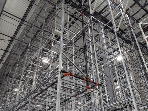 Tall steel storage racking seen from the floor, looking up